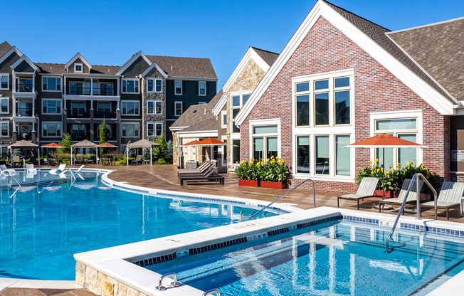 a swimming pool with an apartment building in the background