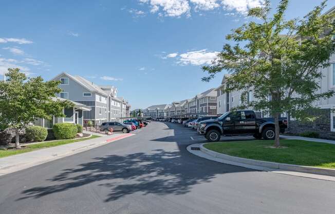 a row of houses on the side of a street with cars parked