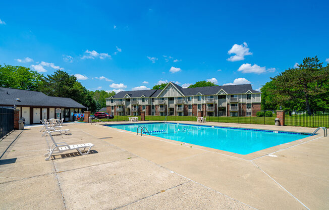 Lounge Chairs on Sundeck by Large Pool at Waverly Park Apartments, Lansing