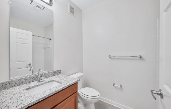 a bathroom with a sink toilet and a mirror