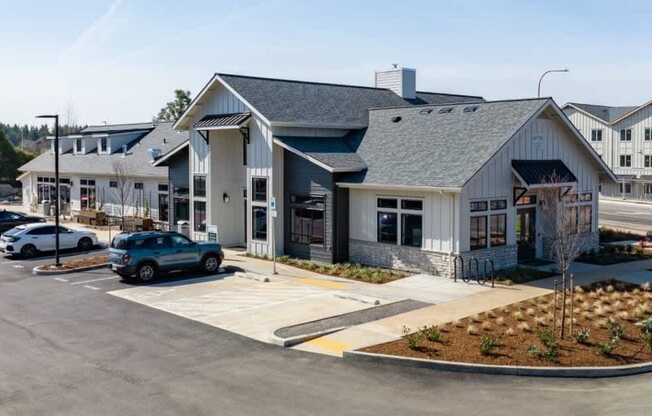 a building with a parking lot and cars in front of it at Sonder Fields in Happy Valley, OR