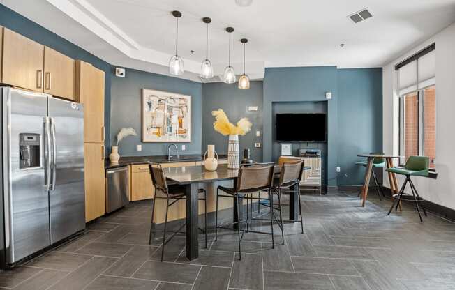 a kitchen with stainless steel appliances and a table with chairs