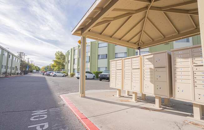 a building with mailboxes on the side of a street