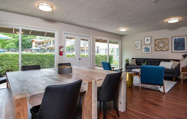 a dining room table with chairs in front of a living room