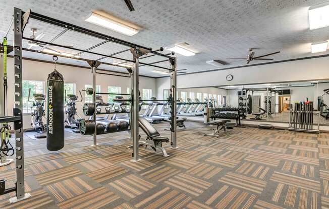 a spacious fitness center with cardio machines and weights