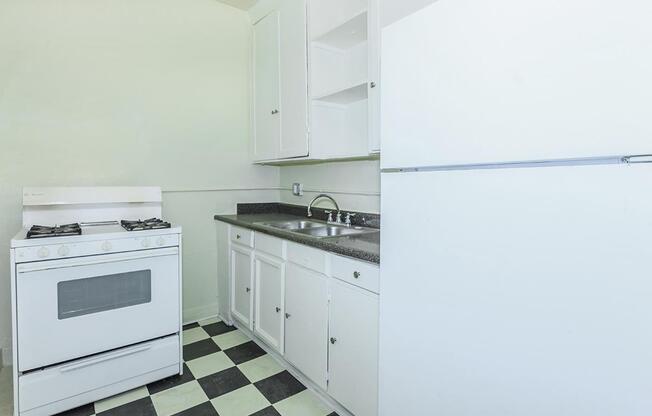 a white stove top oven sitting inside of a kitchen