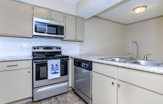 a white stove top oven sitting inside of a kitchen