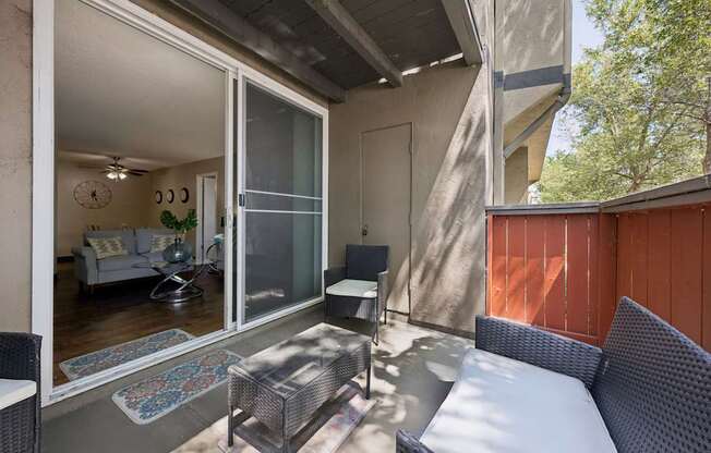 A patio with a couch, table, and chairs.