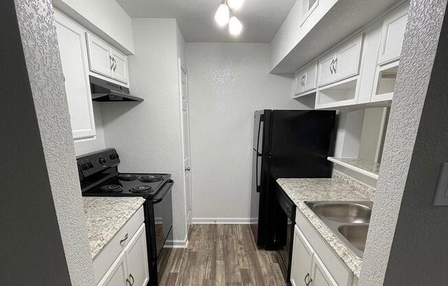 a kitchen with a stove sink and refrigerator