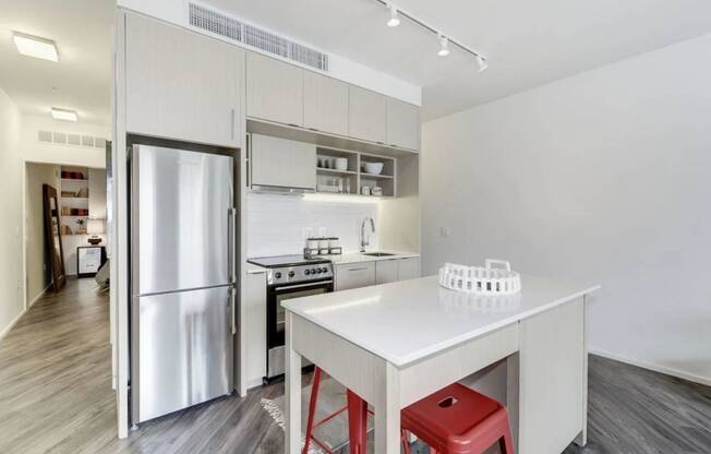 a kitchen with a white counter and a refrigerator