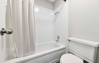 Explore the sleek elegance of this minimalist bathroom, blending comfort with style.