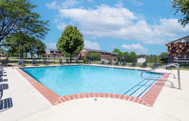 Outdoor pool with seating at Archer's Pointe.