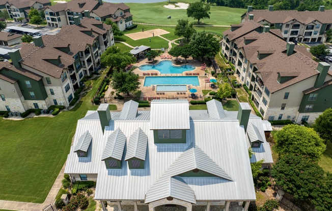 an aerial view of an apartment complex with a swimming pool