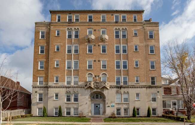 a large brick building with a blue sky in the background