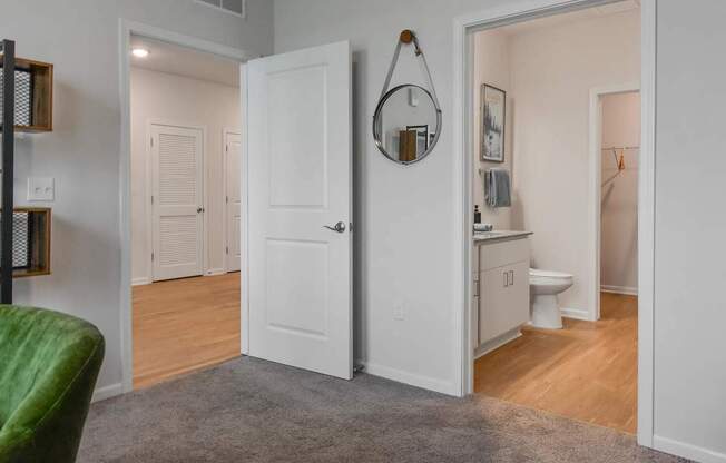 A white door is open to a bathroom.