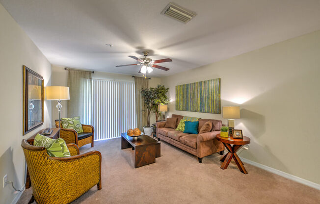 A living room with a brown couch, a chair, and a coffee table.