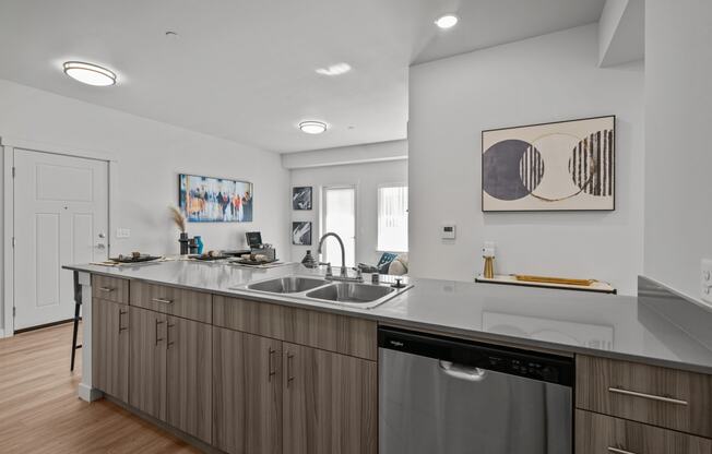 an open kitchen with a large counter top and a sink