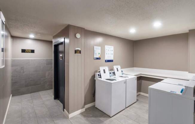One of the clothes care centers near a trash chute at Cambridge Court Apartments in Lake Highlands, Dallas, TX.