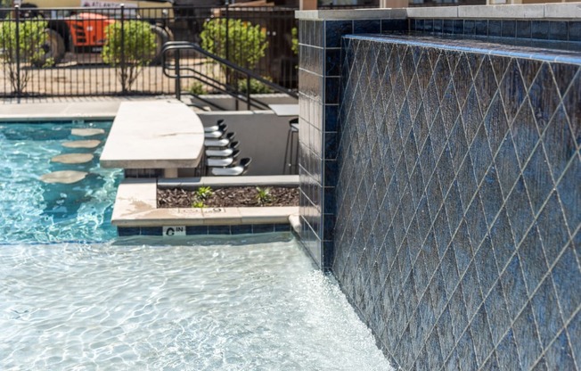 a swimming pool with a retaining wall and a water feature at The Bend Arbordale, Williamsburg