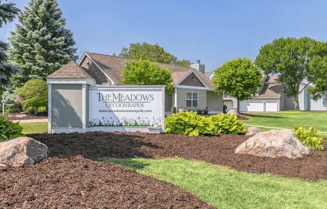 a home with a sign in front of it that says the meadows of commerce