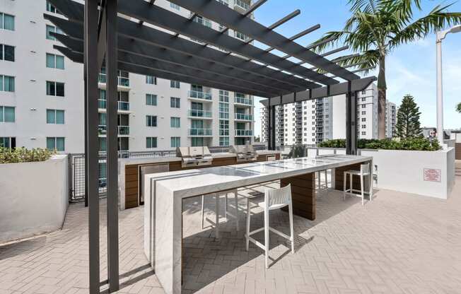a terrace with a table and chairs and a pergola