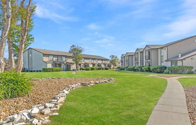 A row of houses with a stone pathway leading to them.