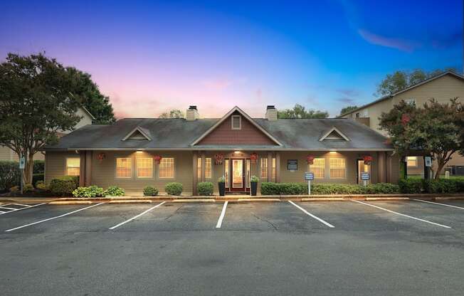 A building with a parking lot in front of it.