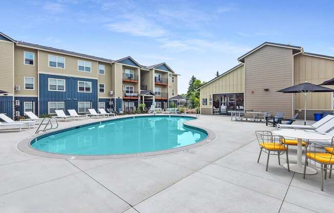 our apartments have a resort style pool with chairs and umbrellas