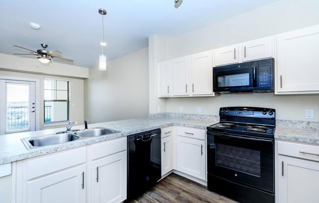 Apartments for Rent in Leander TX - Hills at Leander Spacious Kitchen with Plenty of Counterspace, Fully Equipped with Black Appliances, and Much More