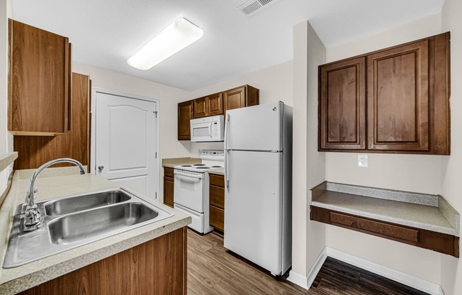 a kitchen with white appliances and wooden cabinets
