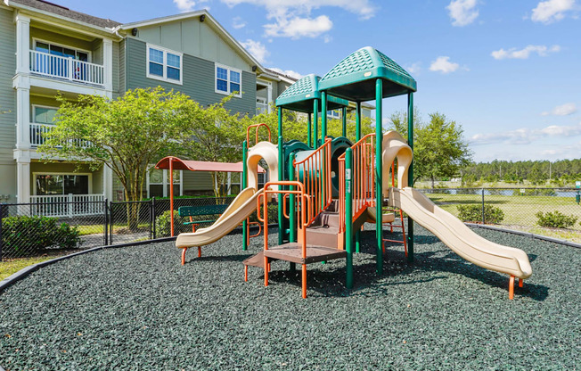 A playground with a green slide and a brown slide.