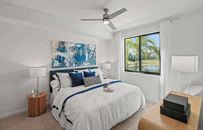 A bedroom with a large bed and a painting on the wall.