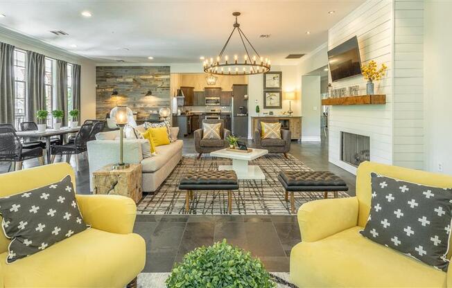 a living room with yellow couches and chairs and a fireplace