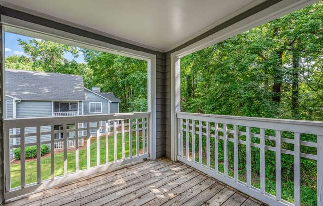 a balcony with a view of a house and trees