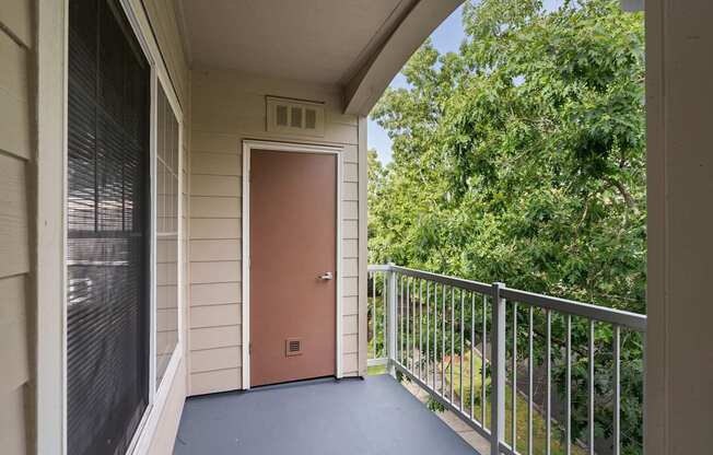 the entrance to a balcony with a door and a railing