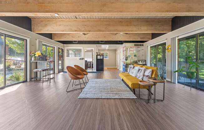 A modern living room with a wooden floor and a large window.