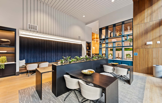 Modern dining and coworking area with a dark table and chairs  at Preston Ridge in Cary, NC.