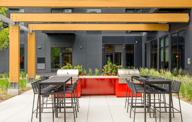 the outdoor seating area of a restaurant with tables and chairs