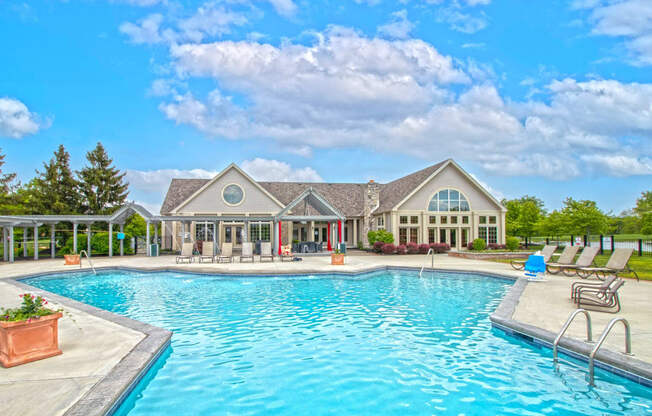 a swimming pool with a house in the background