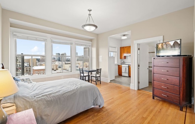 a bedroom with a bed and a dresser and a window