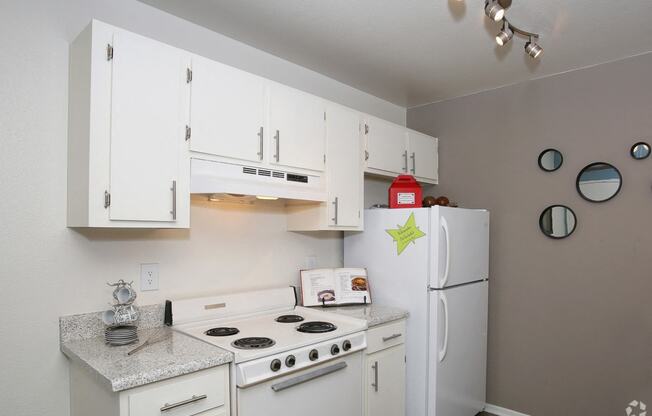 Display of Kitchen with white cabinetry and appliances