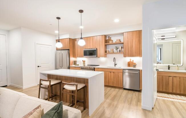 Sleek cabinetry and warm wood tones bring balance and style to every kitchen at Modera Higley Commons.