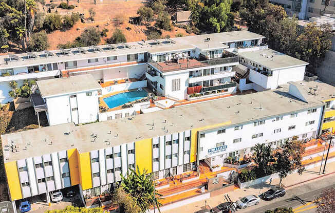 A large white building with a pool in the middle.