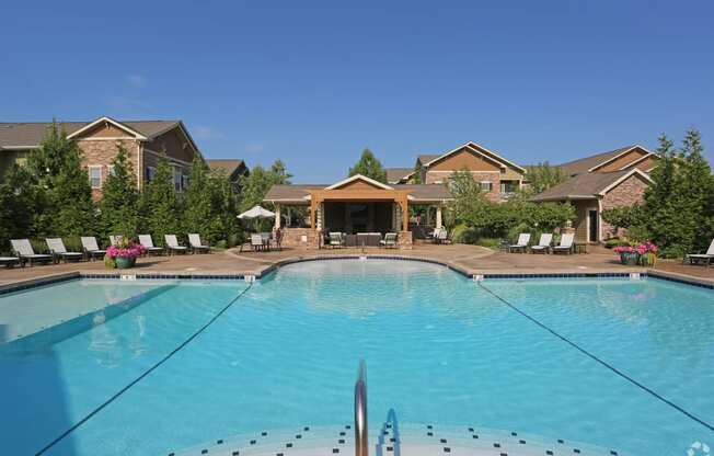 a swimming pool with apartments in the background at Sovereign at Overland Park, Overland Park, KS  