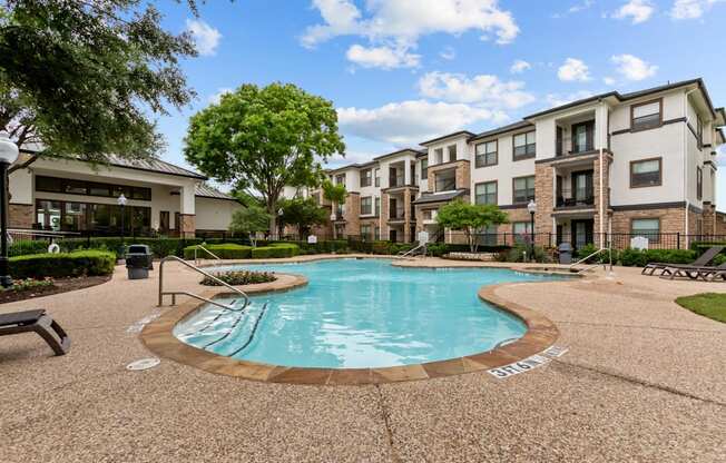 A swimming pool surrounded by apartment buildings.