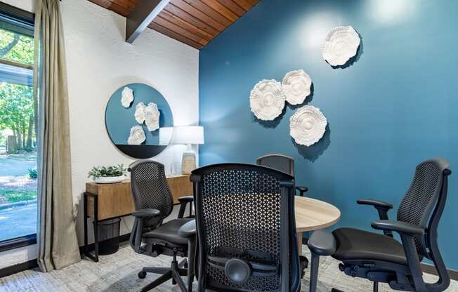 a conference room with a table and chairs and a window