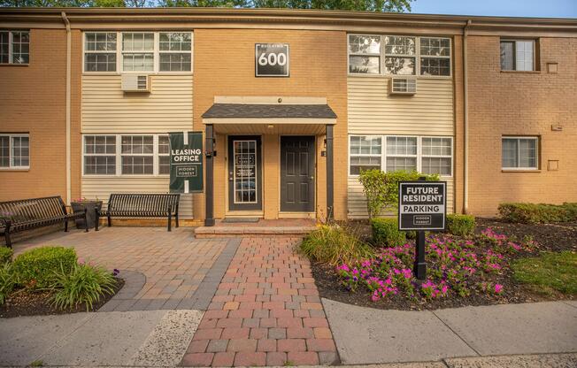 a house with bushes in front of a brick building
