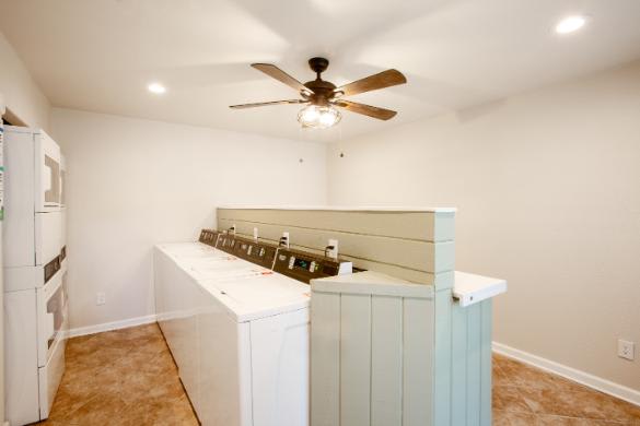 A room with a washer and dryer stacked on top of each other.