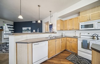 a kitchen with white appliances and wooden cabinets