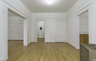 a living room with white walls and doors and a wood floor at Clay & Tiffany, Portland, OR, 97201
